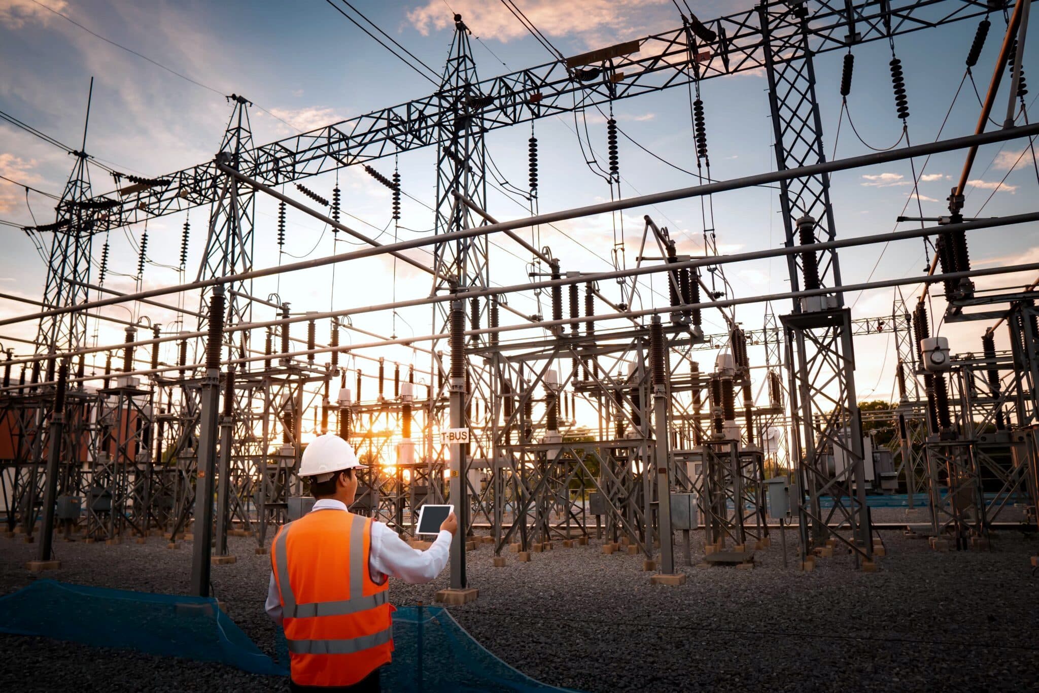 Engineer inspecting electrical substation during commissioning authority review.